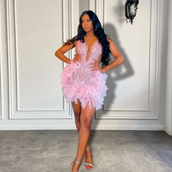 Pink homecoming dress with sheer neckline and feather details