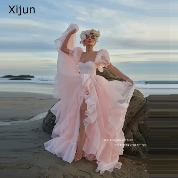 Pink homecoming dress with short puff sleeves, ruffles, and slit